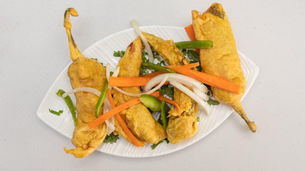 Hari Mirchi Bhajia · Fresh green chilis stuffed with potato spicy mixture and dipped in a batter and fried, served with chutney.