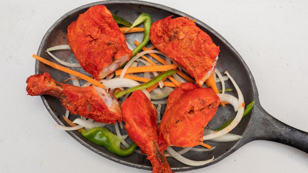Tandoori Chicken · Chicken marinated in yogurt and fresh mild spices and roasted over charcoal in the tandoor.