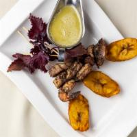 Jerk Menag A Trios · Jerked trio of shrimp, scallops, organic chicken brochettes served with fried sweet plantain...