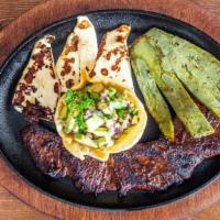 Platillo Bistec Churrasco / Skirt Steak Plate · Churrasco marinado a la parrilla servido con almohadilla de cactus, pico de gallo y queso fr...