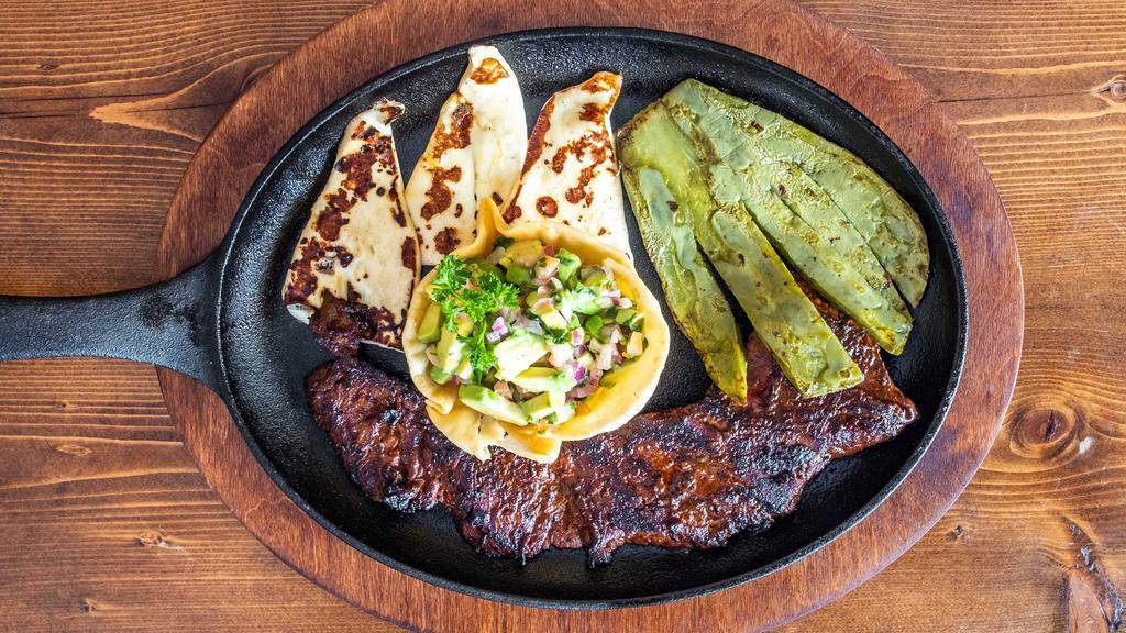 Bistec Churrasco Platillo · Grilled marinated skirt steak served with cactus pad, pico de gallo, and fresh cheese. Served with your choice of side.