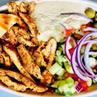 Halal Chicken Platter · Hearty halal chicken served over rice with a side of salad, house made white sauce, and spic...