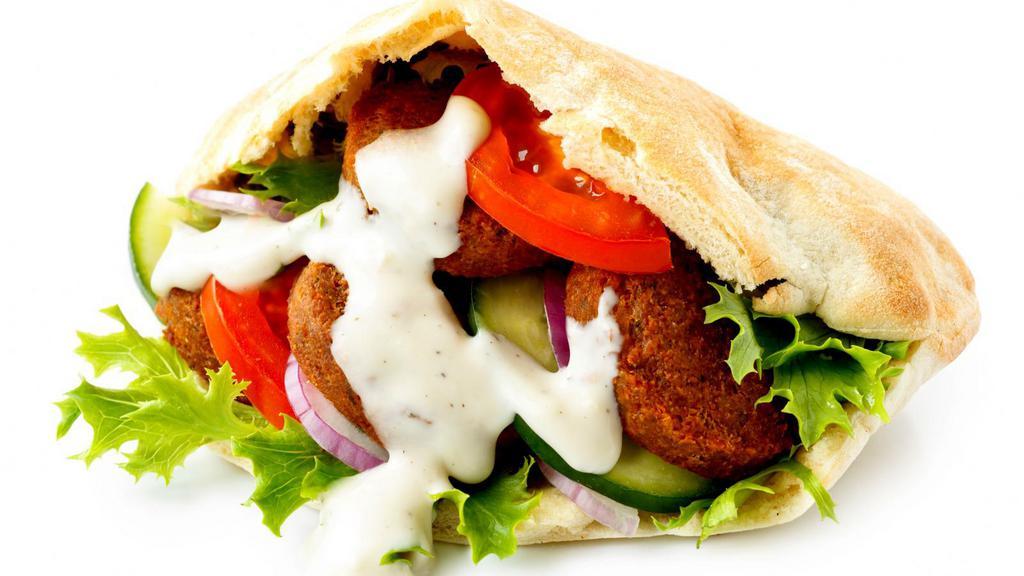 The Falafel Sandwich · Crispy falafels, salad, house-made white sauce and hot sauce served in warm pita bread.
