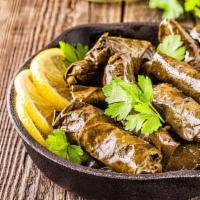 Stuffed Grape Leaves · Spiced rice prepared with fresh dill, mint, and lemon juice rolled in.