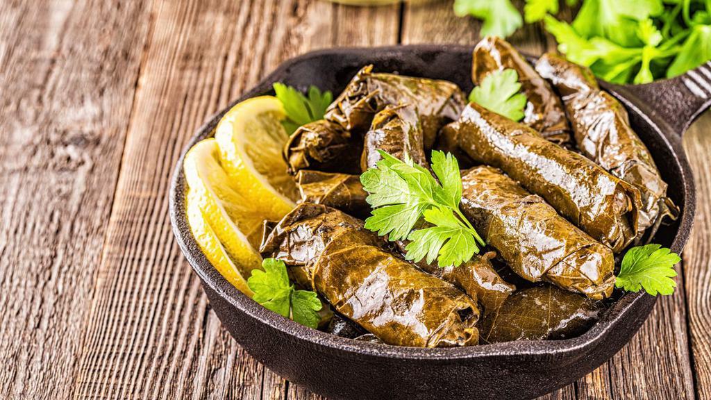 Stuffed Grape Leaves · Spiced rice prepared with fresh dill, mint, and lemon juice rolled in fresh grape leaves.