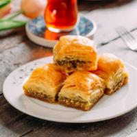 Baklava · Pastry filled with layer of crunchy pistachios and sweet honey topped with a honey drizzle.