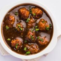 Vegetable Manchurian · Vegetable koftas fried until golden-brown and tossed with onions and a dry chili garlic sauce.