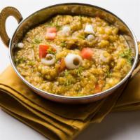 Baingan Bharta · Fresh roasted eggplant with sautéed garlic, ginger and red onions cooked in vegetable oil. S...