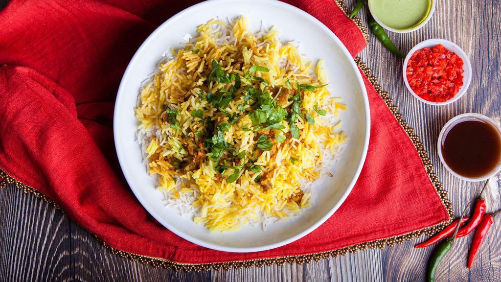 Chicken Biryani · Fresh basmati rice made with pieces of marinated chicken and various Indian herbs, spices and dry fruit.