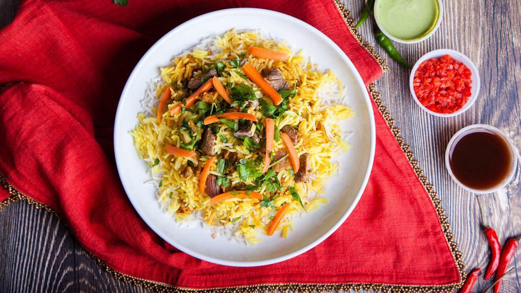 Goat Biryani · Fresh basmati rice made with pieces of marinated goat and various Indian herbs and spices.