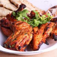 Tandoori Chicken · Fresh chicken marinated in yogurt and mild spices.
