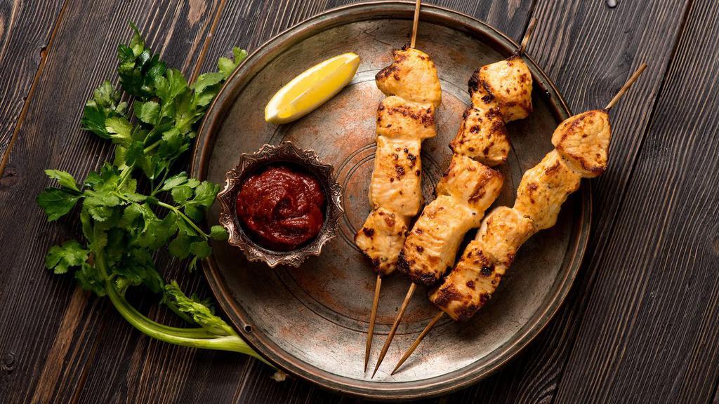 Chicken Malai Kebab  · Fresh cubed chicken marinated in mild herbs, sour cream, and cashew nuts in a charcoal oven.