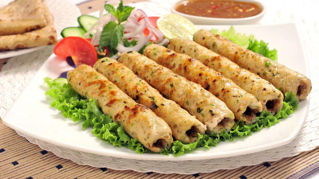 Chicken Seekh  Kebab · Pieces of ground chicken seasoned with ginger, garlic, red onions, and cilantro.