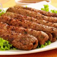 Lamb Seekh Kebab · Pieces of ground lamb seasoned with ginger, garlic, red onions, and cilantro.