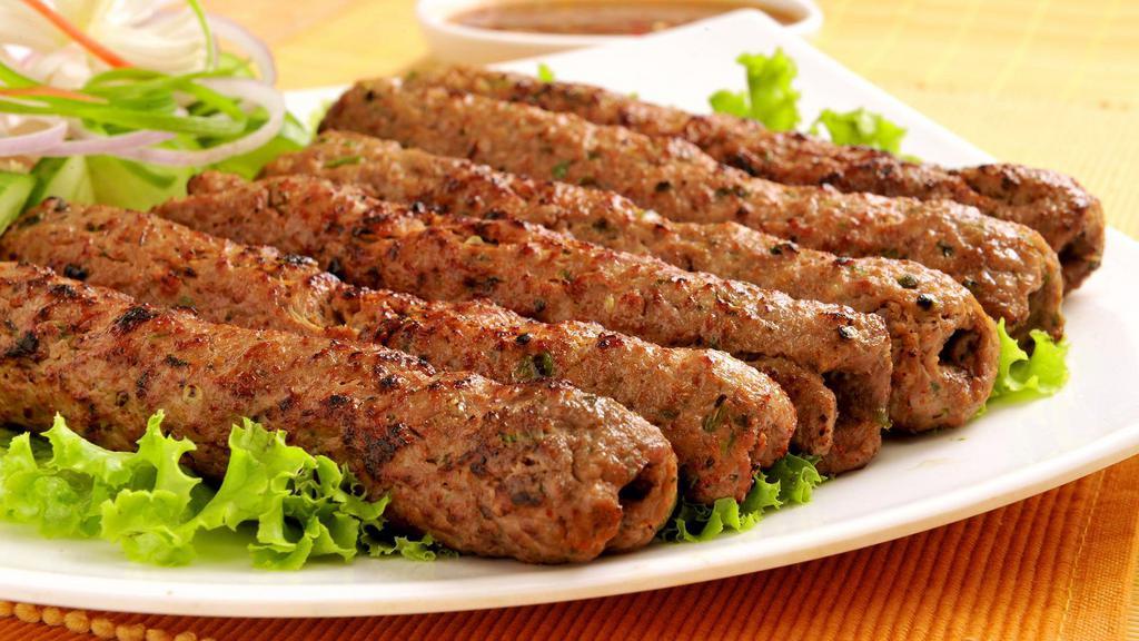 Lamb Seekh Kebab · Pieces of ground lamb seasoned with ginger, garlic, red onions, and cilantro.