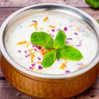 Raita · A yogurt with grated carrots and cucumbers seasoned with salt, grounded cumin and cilantro.
