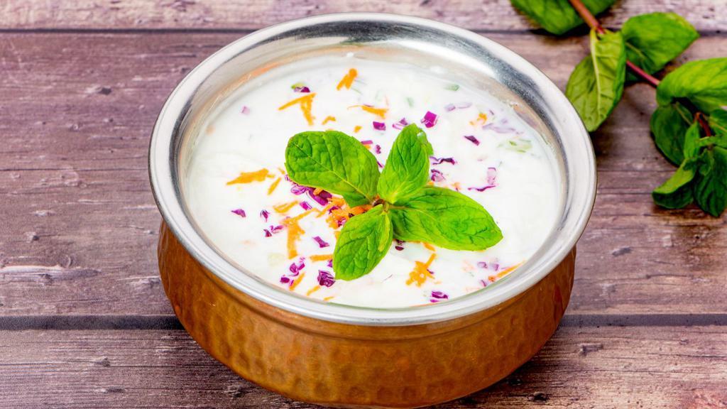 Raita · A yogurt with grated carrots and cucumbers seasoned with salt, grounded cumin and cilantro.