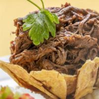Ropa Vieja · Made with shredded skirt steak stew, onions, peppers and tomato sauce.