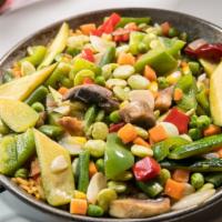 Vegetariana Paella · Made with Spanish rice and assorted mixed vegetables.