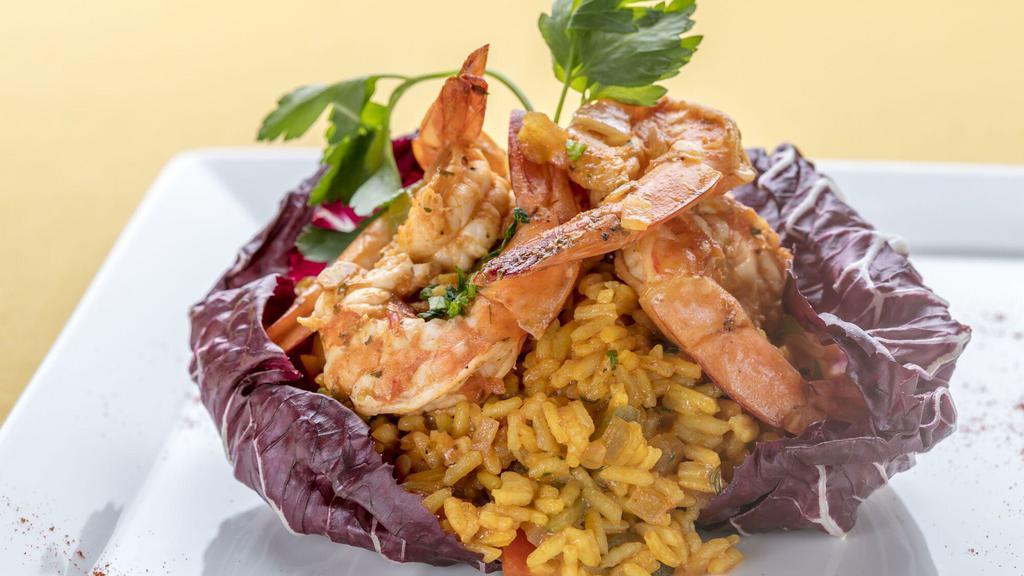 Arroz Con Camarones · Yellow rice with shrimp and vegetables.