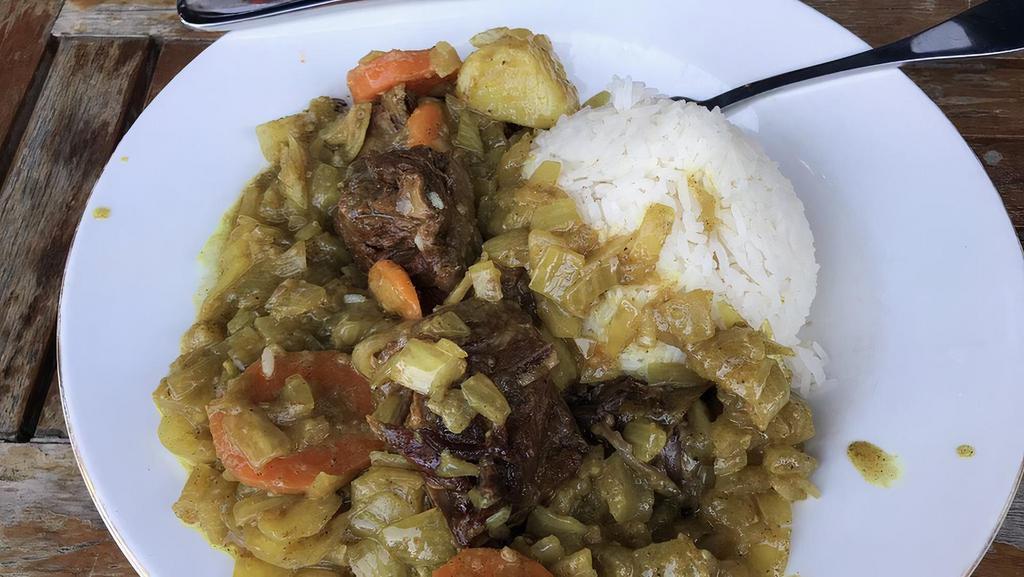 Curry Lamb · Lamb with fresh vegetables prepared in seasoned curry sauce served with white rice.