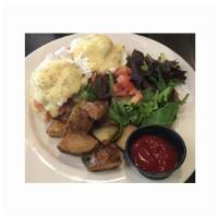 Eggs Benedict · Poached eggs served on toasted muffins topped with hollandaise sauce served with salad and h...
