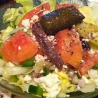 Greek Salad · Lettuce, pepperoncini, stuffed grape leaves, tomatoes, Greek olives, feta cheese, cucumbers,...