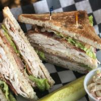 Turkey Club · Triple decker piled with turkey, bacon, lettuce & tomatoes on toasted white bread