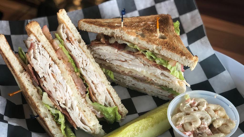 Turkey Club · Triple decker piled with turkey, bacon, lettuce & tomatoes on toasted white bread