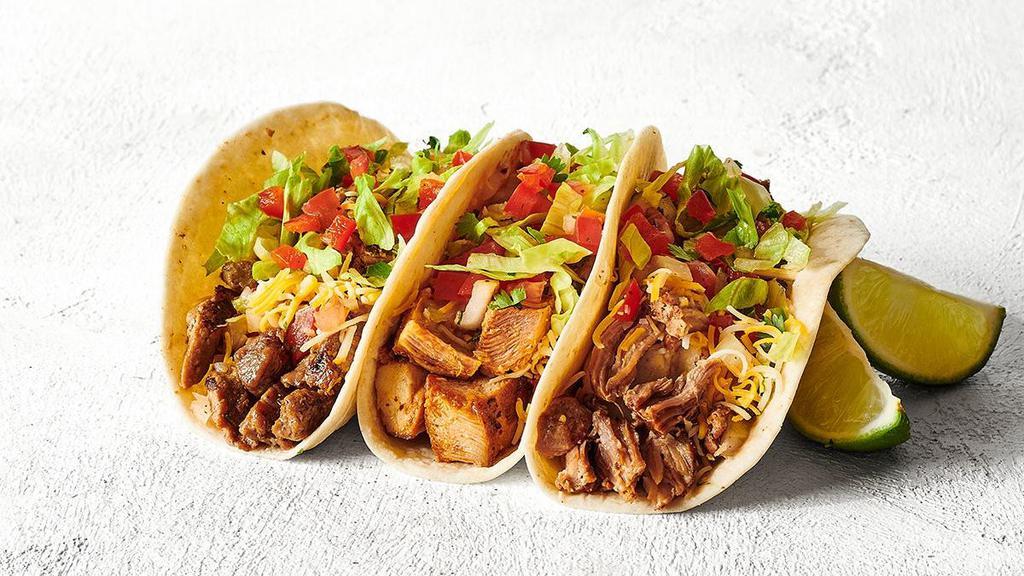 Three Tacos · Want a relaxing activity? We suggest building your own tacos - soft or crunchy tortillas folded and filled with your choice of protein and fresh and flavorful ingredients. Nom nom nom.