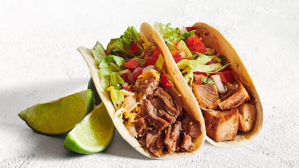 Two Tacos · Want a relaxing activity? We suggest building your own tacos - soft or crunchy tortillas folded and filled with your choice of protein and fresh and flavorful ingredients. Nom nom nom.