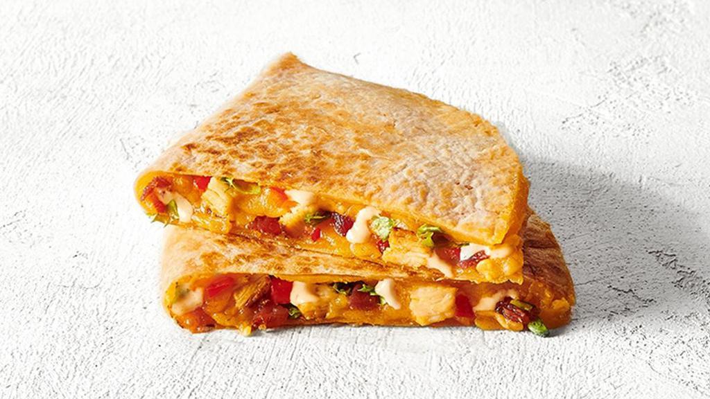 Chicken Club Quesadilla · Think BLT, but better - grilled chicken, bacon, shredded lettuce, cheese, and chipotle ranch dressing layered in a warm quesadilla.