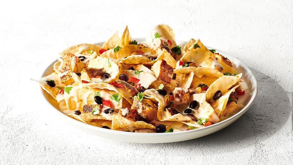 Nachos · Build the nachos of your dreams. Topped off with our famous queso.