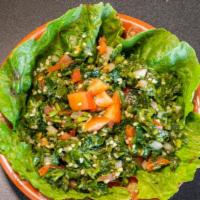 Tabbouleh Salad · Chopped parsley, cracked wheat, freshly cut tomatoes, onions and fresh mint in an extra-virg...