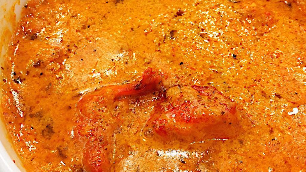Chicken Tikka Masala · Boneless tandoori chicken pieces cooked in tomato and onion cream sauce. Served with basmati rice and one plain naan.