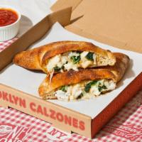 Williamsburg Calzone · Calzone with fresh spinach, garlic, creamy ricotta, melted mozzarella, and a side of marinara.