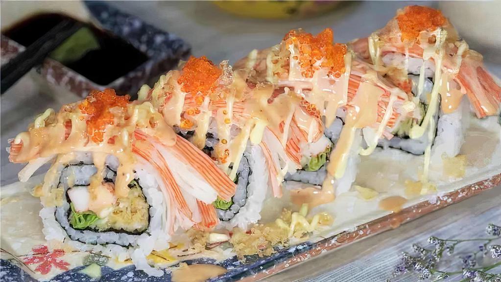 Sake Roll · Salmon tempura, avocado inside, crab on top with spicy mayo and eel sauce.