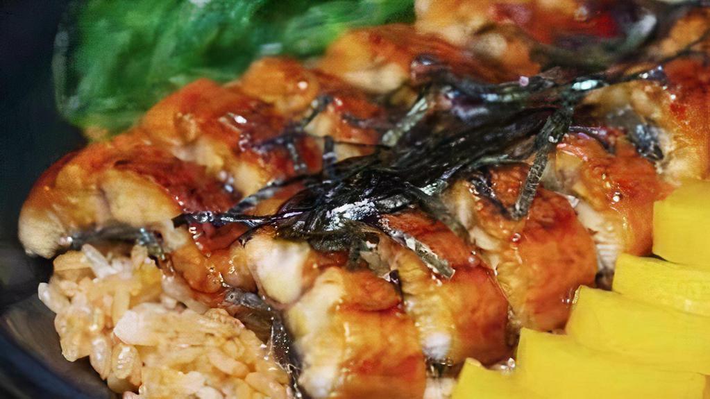 Unagi Don · Toasted eel glazed with special eel sauce over a bowl of rice, with Japanese pickles.