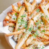 Truffle Fries · Ultimate crispy fries tossed with withe truffle oil, 5 months aged Parmesan cheese, and pars...