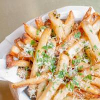 Truffle Fries · Ultimate crispy fries tossed with white truffle oil, 5 months aged Parmesan cheese, and pars...