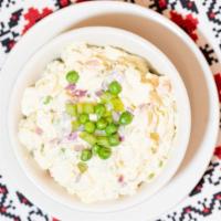 Salat Olivier · Russian style salad. Diced potato, egg, pickle, carrot, kovbasa, and peas dressed in mayonna...