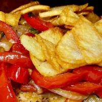 Sicilian Pork Chops · Grilled pork chops with sweet and hot peppers, onions, and fried potatoes.