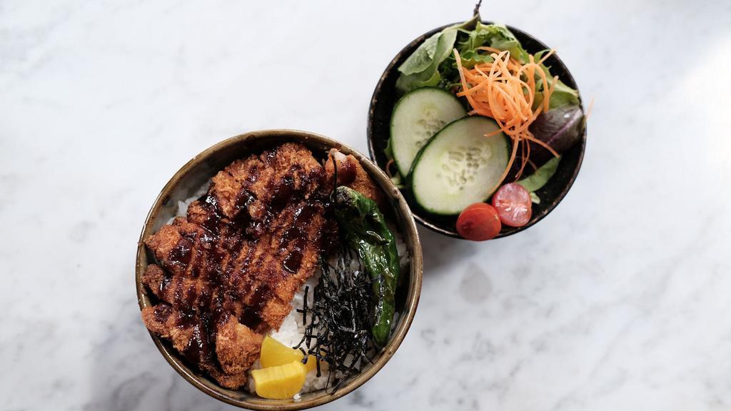 Katsu Don Bowl · Fried pork cutlet and sliced onion coated with egg and served on white rice.