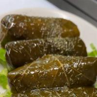 Dolmades (6) · Vegan. Rice & herb stuffed grape leaves, served with a side of tzatziki.