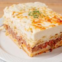 Pastitsio · Greek-style lasagna with penne macaroni, ground beef &béchamel cheese sauce, served with a s...