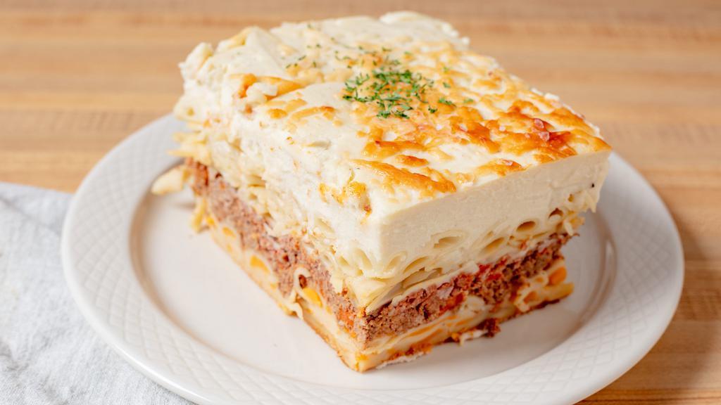 Pastitsio · Greek-style lasagna with penne macaroni, ground beef &béchamel cheese sauce, served with a side salad.