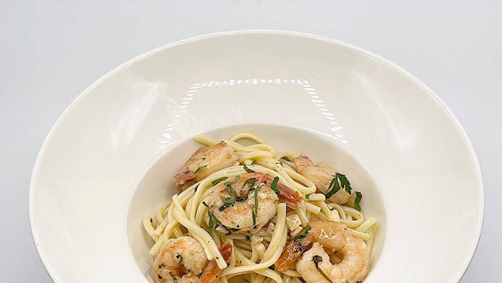Shrimp Scampi · tender jumbo tail-on shrimps, on a bed of linguine in a white wine sauce with fresh Parmesan cheese