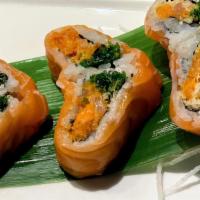 Passion Roll · Spicy Tuna, Salmon, Yellowtail & Seaweed Salad Topped with Salmon in a heart shape.