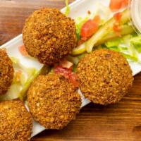 Falafel · This classic dish is fried to a crisp explosion of flavors, five chickpea dumplings accompan...