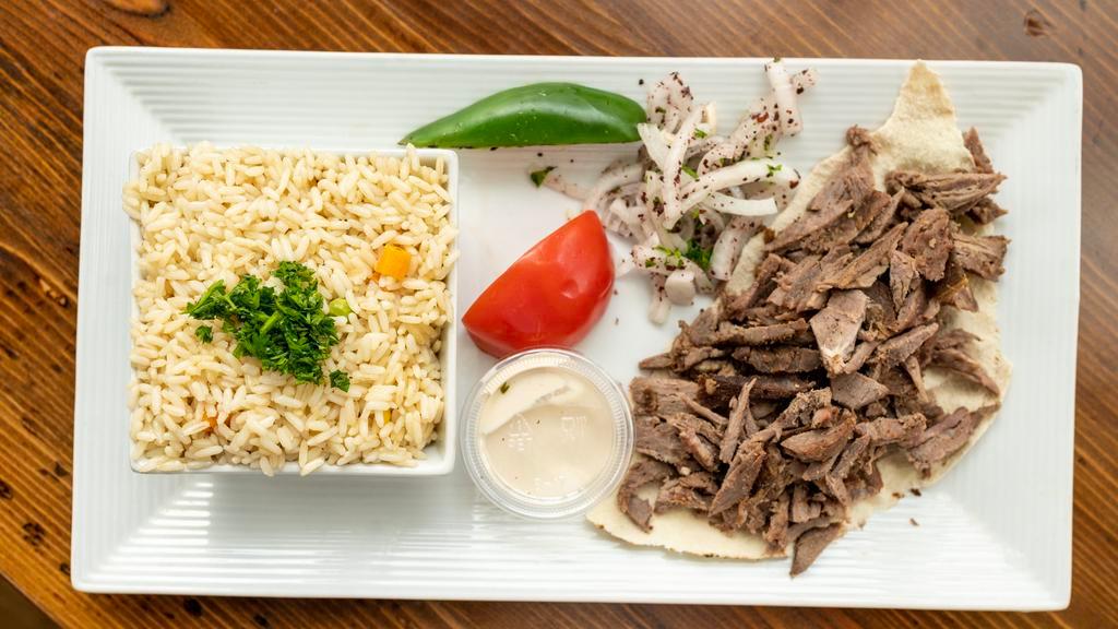 Shawarma Platter · An old city original: thinly sliced top sirloin, marinated with our blend of spices, cooked all day on our vertical rotisserie, served with onions and tahini dressing.